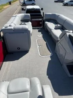 Slide: The Image of 2024 Regency 250 DL3 pontoon boat with spacious seating and modern design. - 10