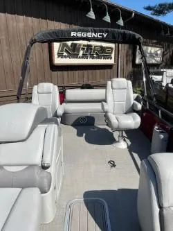 Slide: The Image of 2024 Regency 250 DL3 pontoon boat with spacious seating and modern design. - 5