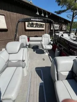 Slide: The Image of 2024 Regency 250 DL3 pontoon boat with spacious seating and modern design. - 8
