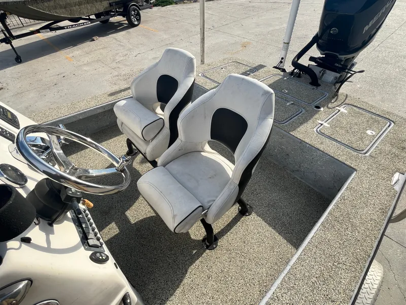 Slide: The Image of 2013 Haynie 24 HO boat interior with dual seats and steering wheel. - 10