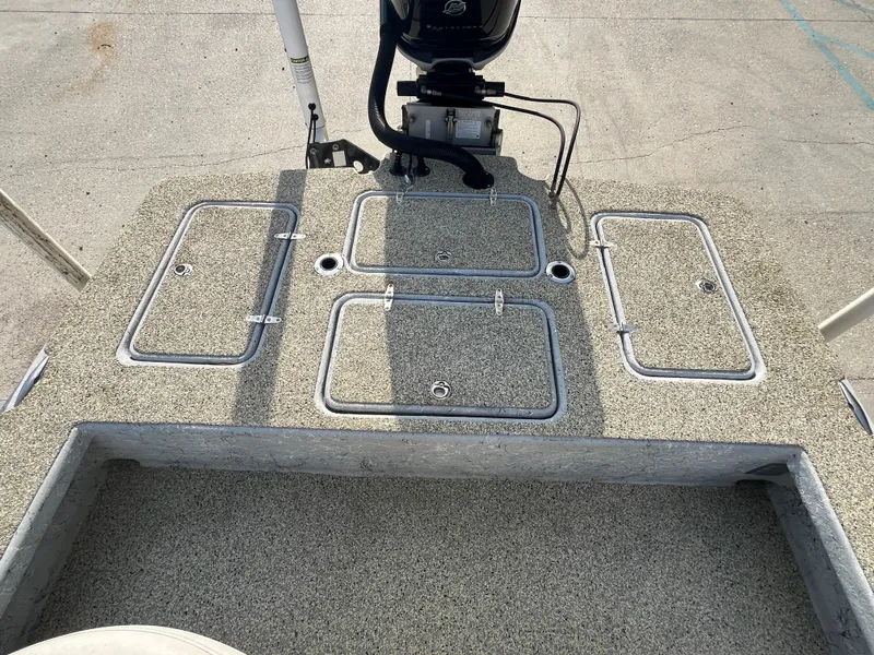 Slide: The Image of 2013 Haynie 24 HO boat deck with storage compartments and motor mount. - 11