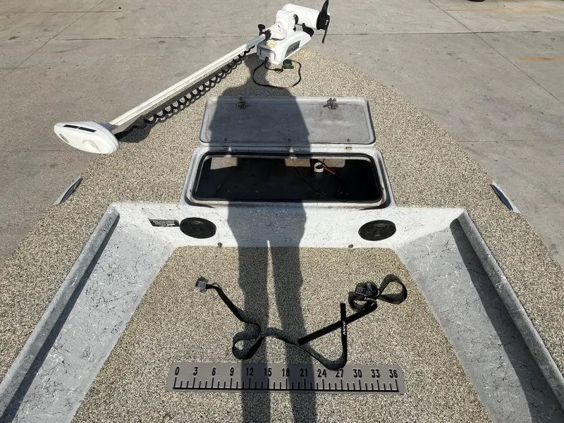 Slide: The Image of 2013 Haynie 24 HO boat deck with open hatch and trolling motor. - 13