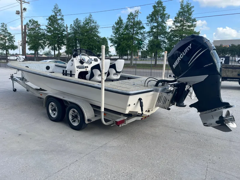 Slide: The Image of 2013 Haynie 24 HO boat on trailer with Mercury outboard motor, parked outdoors. - 5
