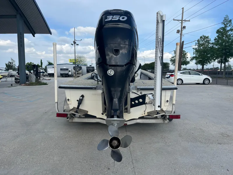 Slide: The Image of 2013 Haynie 24 HO boat with a 350 horsepower engine, parked outdoors. - 6