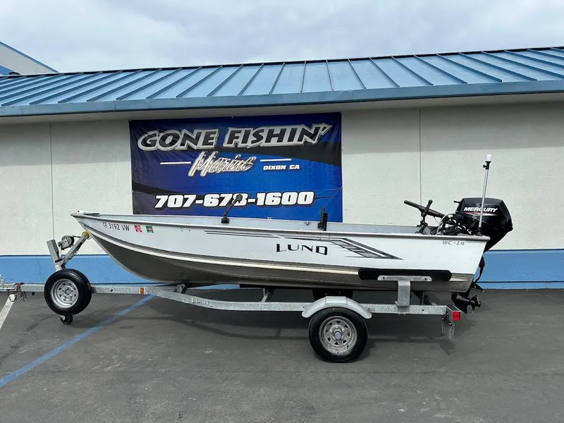 Slide: The Image of 2022 Lund WC-14 boat on trailer, displayed at Gone Fishin' Marine dealership. - 1