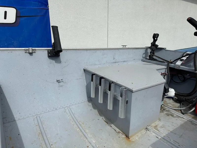 Slide: The Image of 2022 Lund WC-14 boat interior with rod holders and steering console. - 11