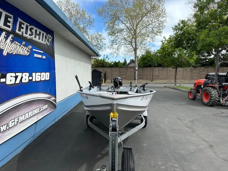 Slide: The Image of 2022 Lund WC-14 boat on trailer outside marine shop. - 3