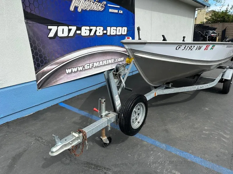Slide: The Image of 2022 Lund WC-14 boat on trailer, parked outside GF Marine dealership. - 4