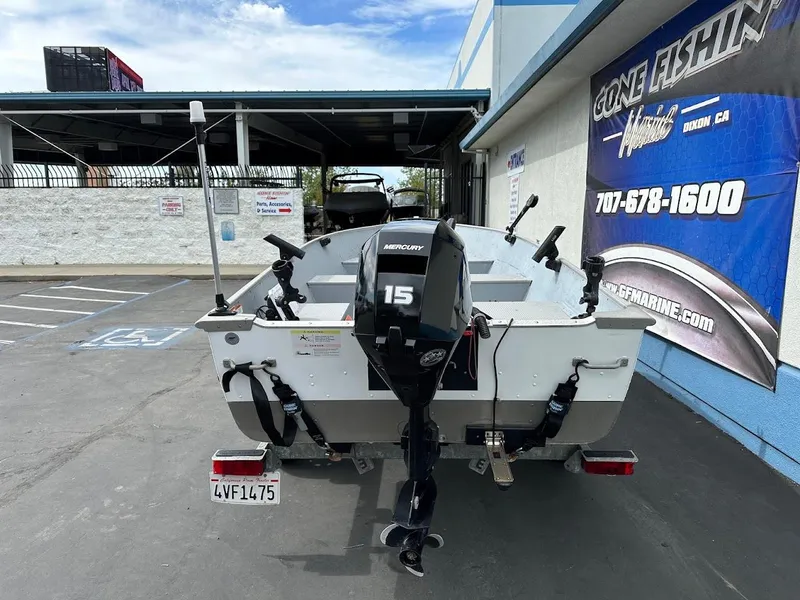 Slide: The Image of 2022 Lund WC-14 boat with Mercury 15 engine parked at dealership. - 7
