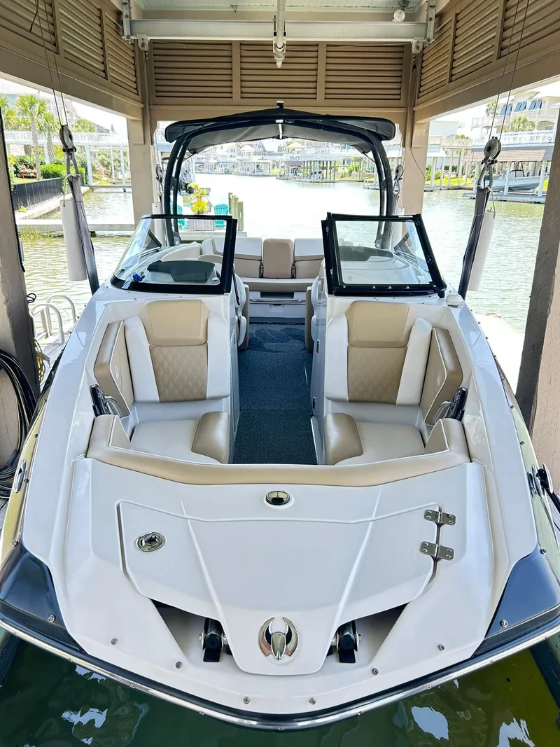 Slide: The Image of 2016 Scarab 255 H.O. Platinum boat docked, featuring spacious seating and sleek design. - 1