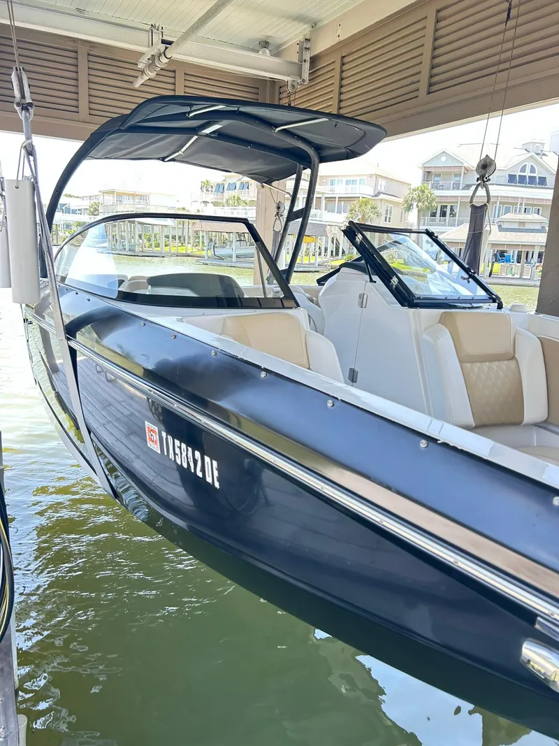 Slide: The Image of 2016 Scarab 255 H.O. Platinum boat docked in a marina setting. - 10