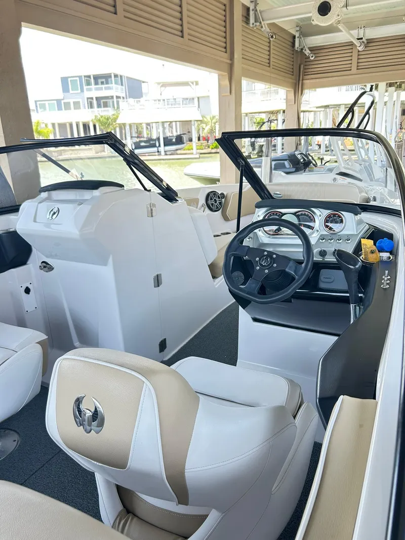 Slide: The Image of 2016 Scarab 255 H.O. Platinum boat interior with steering wheel and seating. - 12