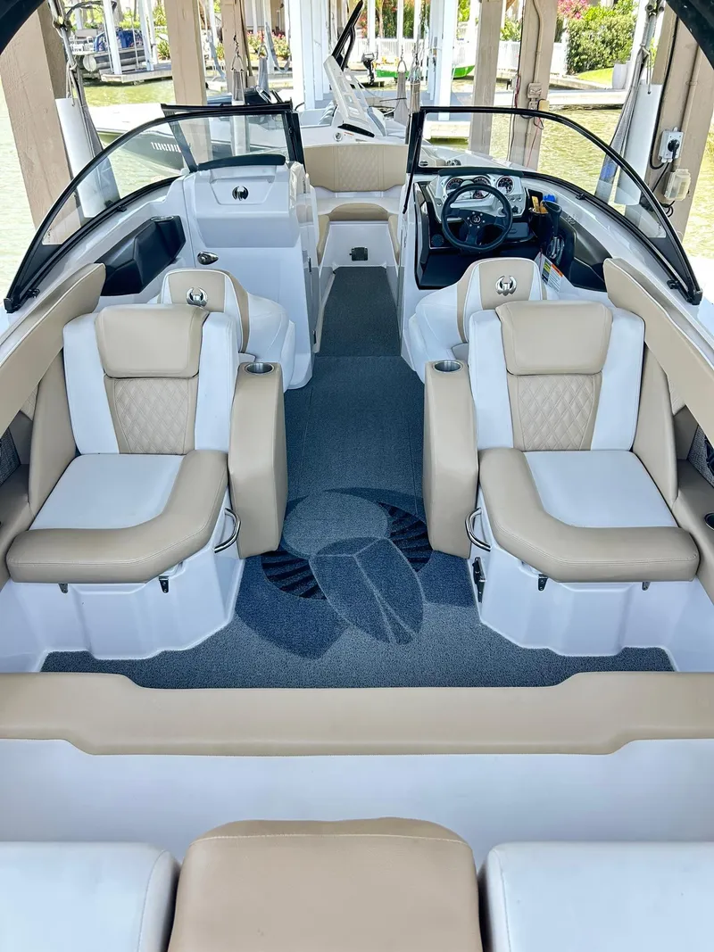 Slide: The Image of 2016 Scarab 255 H.O. Platinum boat interior with beige and white seating. - 13