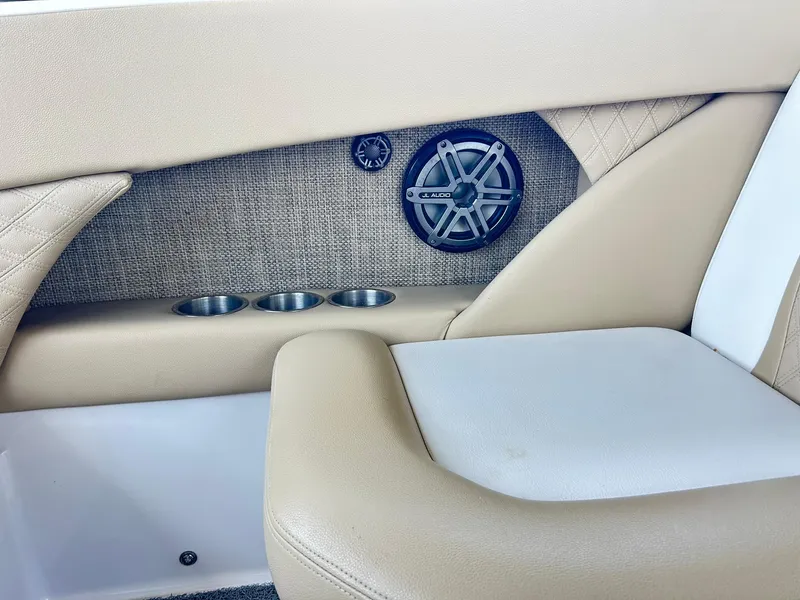 Slide: The Image of Interior of 2016 Scarab 255 H.O. Platinum boat with speaker and cup holders. - 14