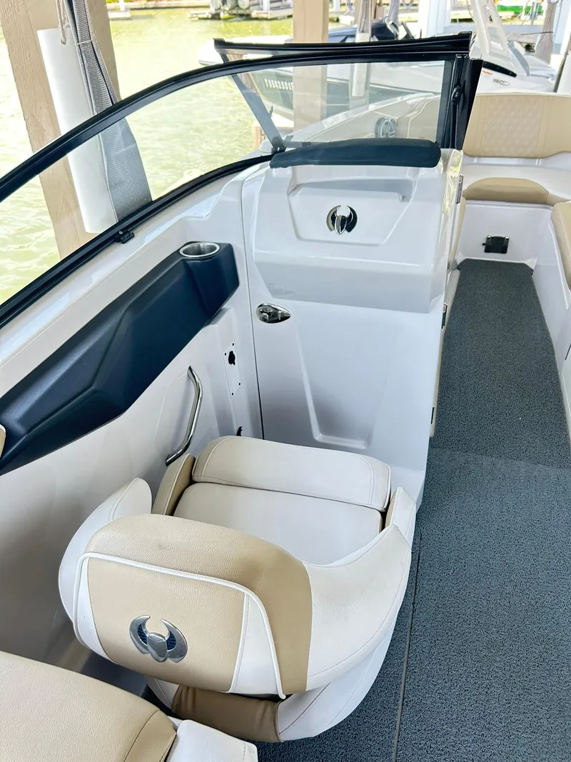 Slide: The Image of 2016 Scarab 255 H.O. Platinum boat interior with beige seating and sleek design. - 15