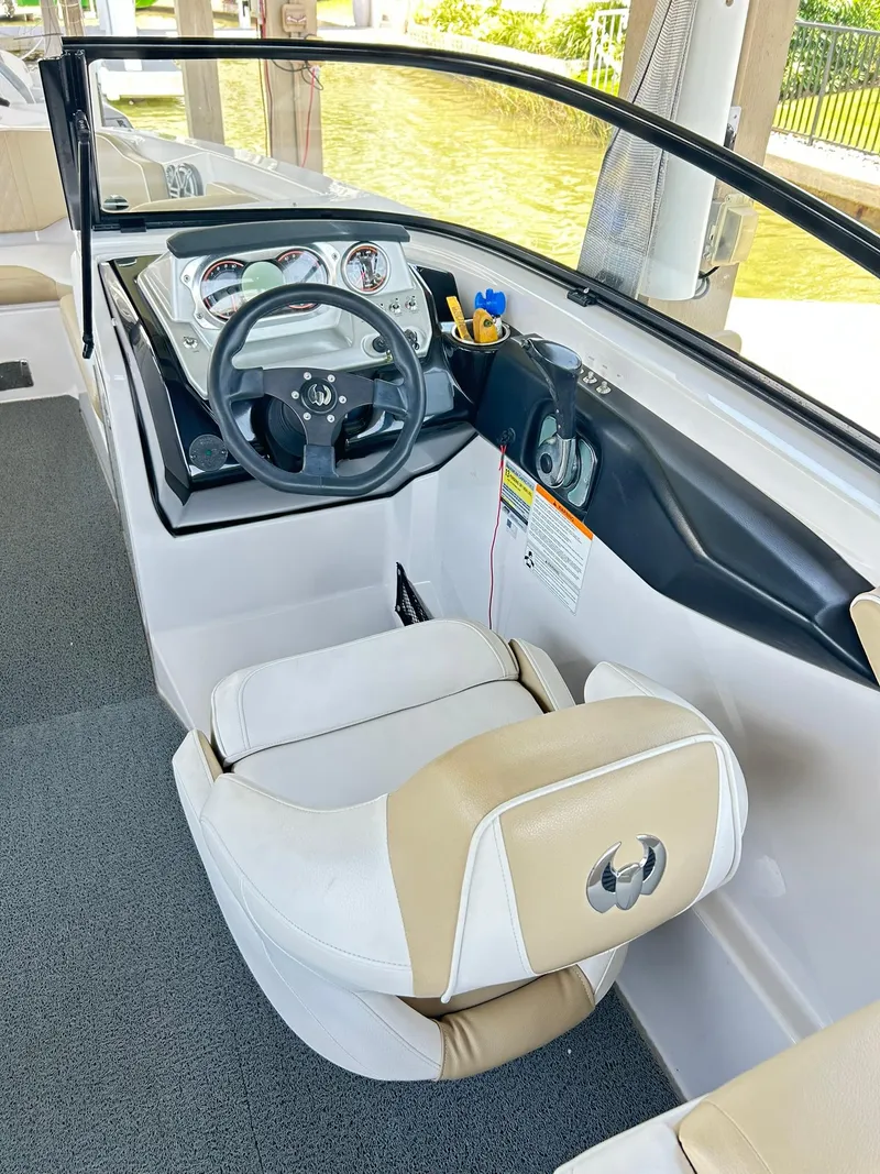 Slide: The Image of 2016 Scarab 255 H.O. Platinum boat interior with steering wheel and dashboard. - 16