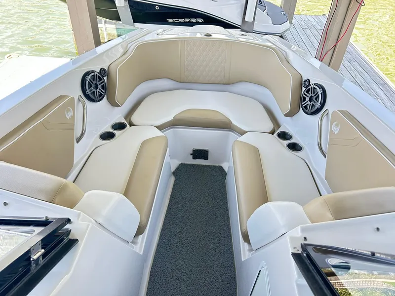 Slide: The Image of Interior of 2016 Scarab 255 H.O. Platinum boat with beige seating and speakers. - 17