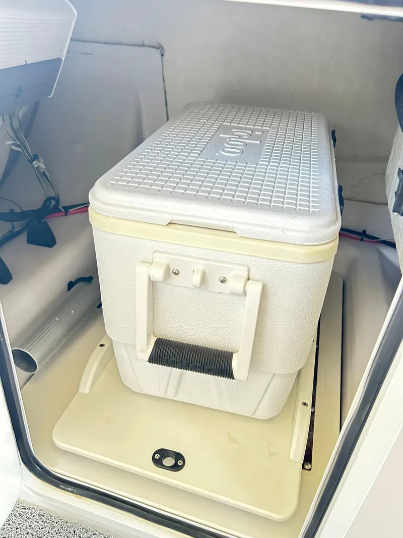 Slide: The Image of Cooler storage in 2016 Scarab 255 H.O. Platinum boat compartment. - 18