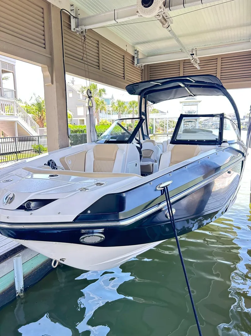 Slide: The Image of 2016 Scarab 255 H.O. Platinum boat docked in covered marina. - 2