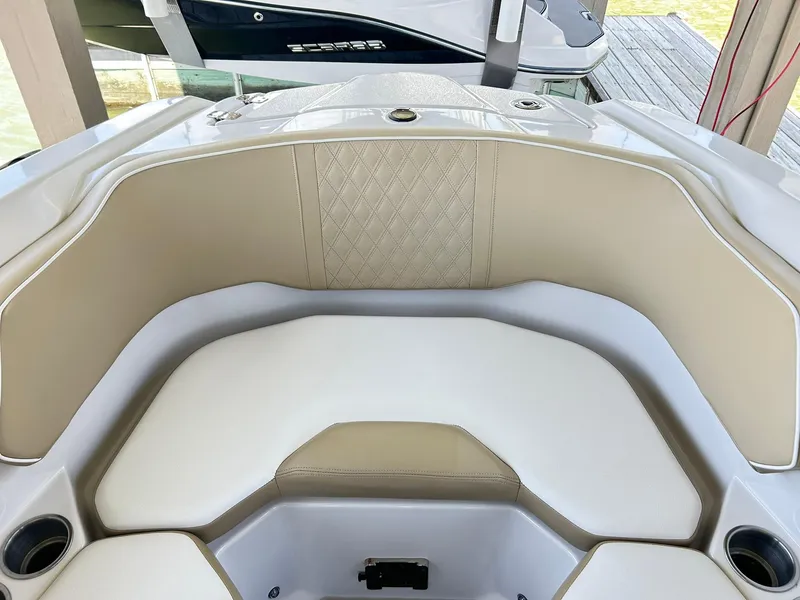 Slide: The Image of 2016 Scarab 255 H.O. Platinum boat interior with beige seating and cup holders. - 21