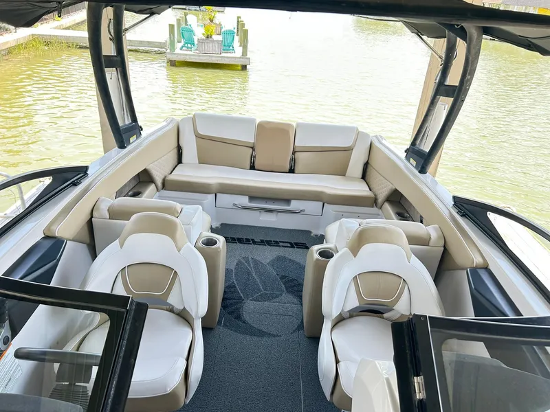 Slide: The Image of 2016 Scarab 255 H.O. Platinum boat interior with beige seating and water view. - 23
