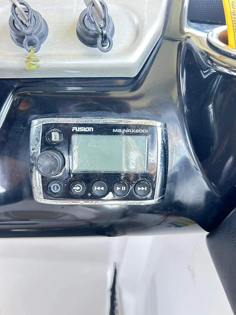 Slide: The Image of Control panel of a 2016 Scarab 255 H.O. Platinum boat with Fusion stereo system. - 26