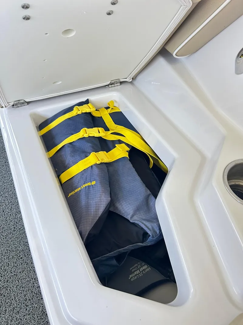 Slide: The Image of Life jacket storage in 2016 Scarab 255 H.O. Platinum boat compartment. - 28