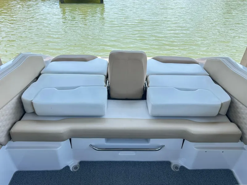 Slide: The Image of 2016 Scarab 255 H.O. Platinum boat interior with cushioned seating by the water. - 29