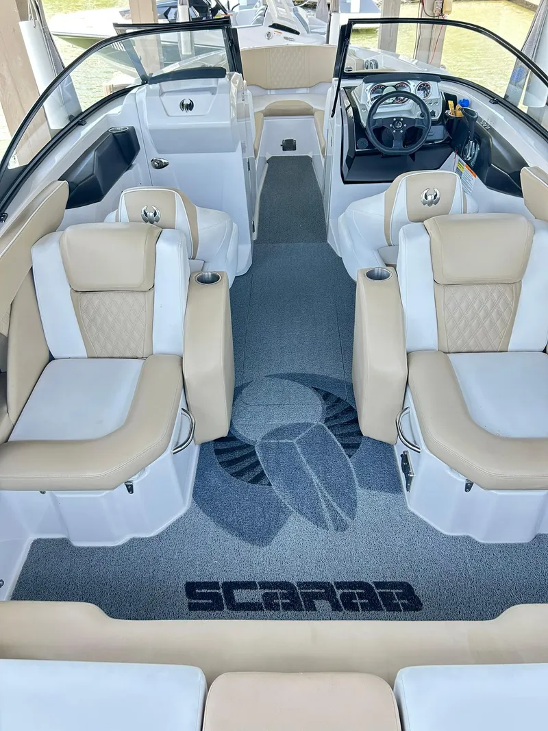 Slide: The Image of Interior of 2016 Scarab 255 H.O. Platinum boat with beige seating and logo carpet. - 33