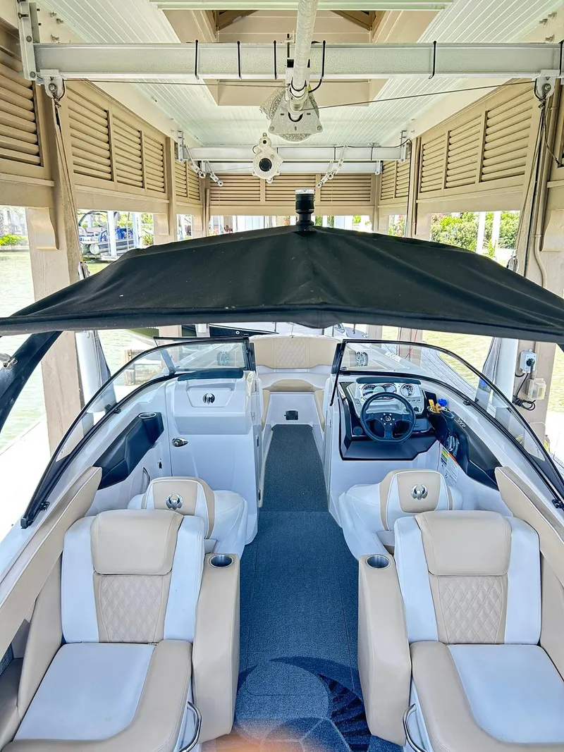 Slide: The Image of 2016 Scarab 255 H.O. Platinum boat interior with beige seating and black canopy. - 35