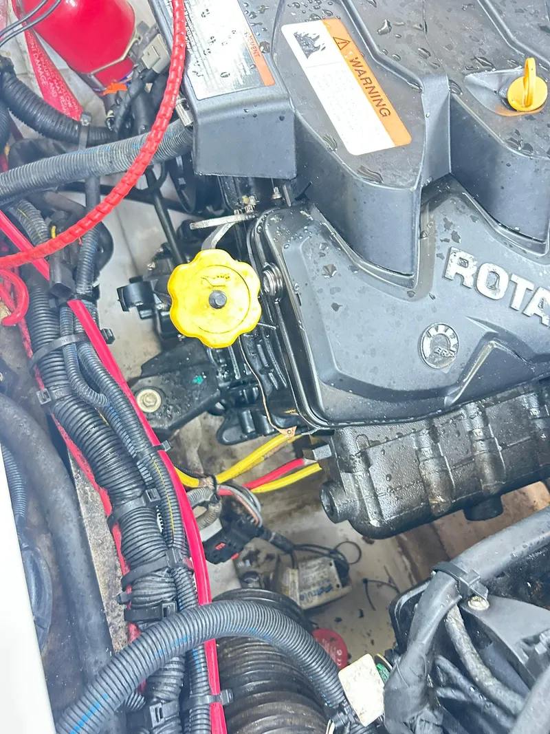 Slide: The Image of Engine compartment of a 2016 Scarab 255 H.O. Platinum boat, featuring detailed wiring and components. - 42