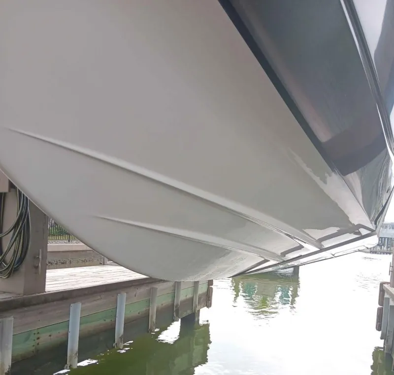 Slide: The Image of 2016 Scarab 255 H.O. Platinum boat hull, docked in calm waters. - 47