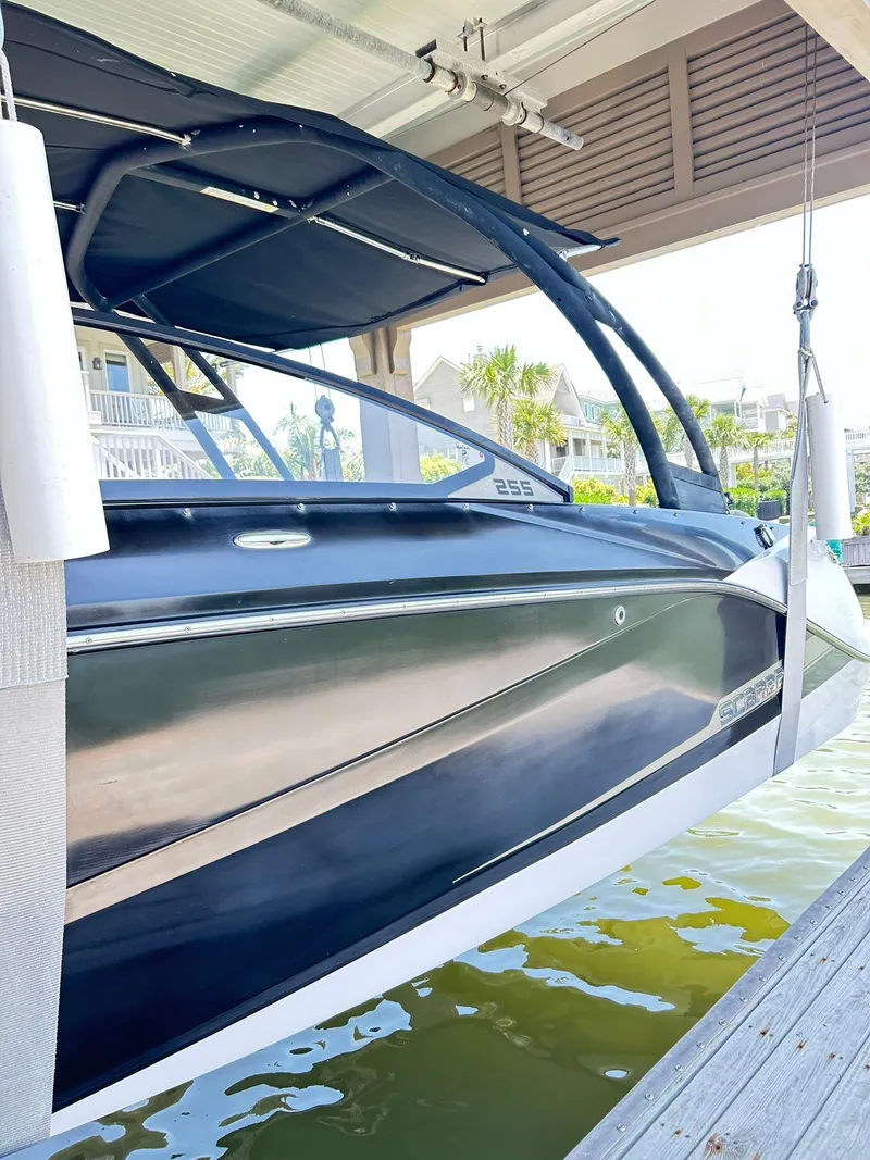 Slide: The Image of 2016 Scarab 255 H.O. Platinum boat docked under a covered structure. - 5