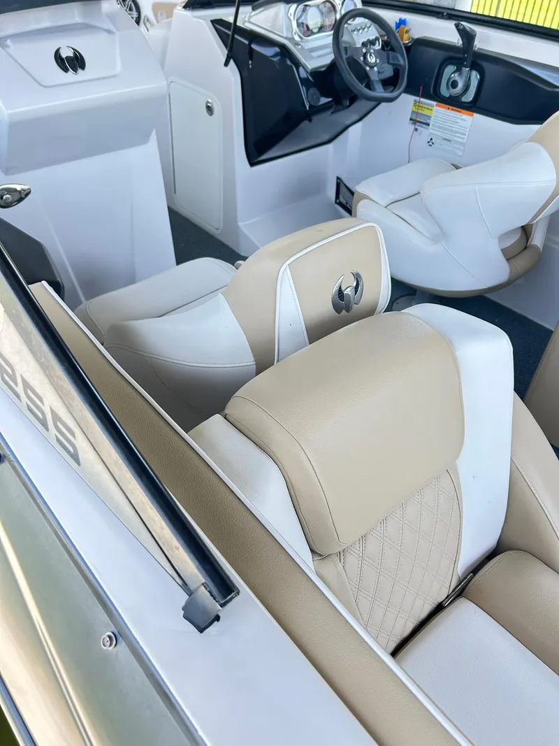 Slide: The Image of Interior of a 2016 Scarab 255 H.O. Platinum boat with beige and white seating. - 6