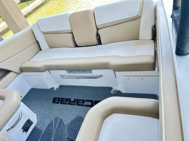 Slide: The Image of Interior of 2016 Scarab 255 H.O. Platinum boat with beige seating and logo carpet. - 7