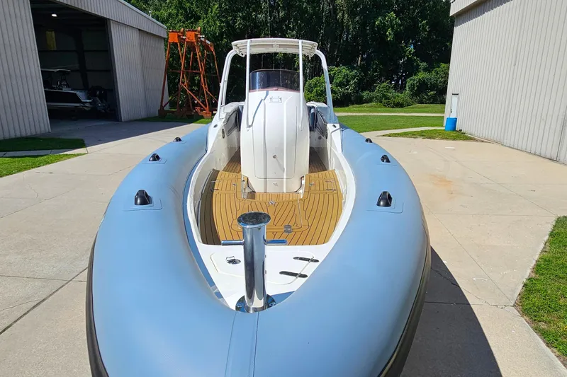 Slide: The Image of 2012 Cougar R10 Rigid Inflatable boat on concrete, near storage buildings. - 10