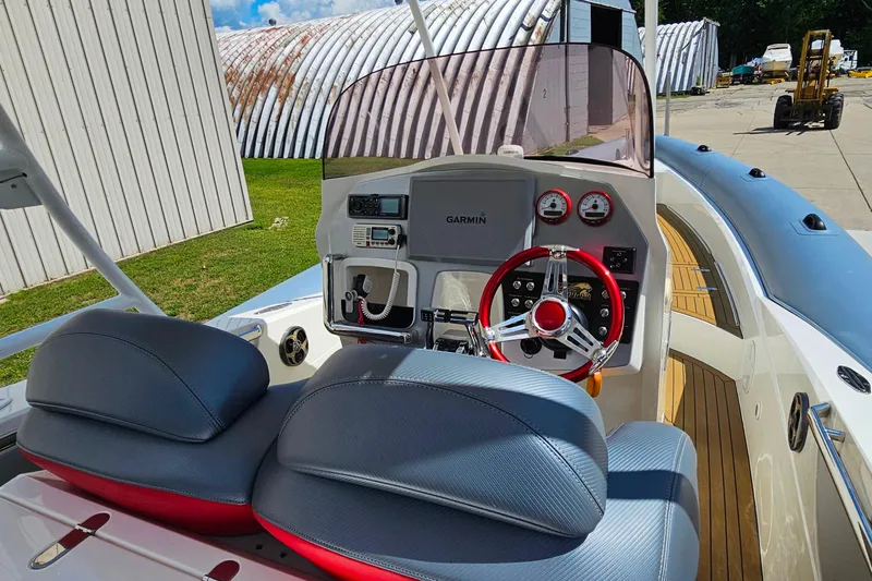 Slide: The Image of Interior of 2012 Cougar R10 Rigid Inflatable boat with modern dashboard and steering wheel. - 14