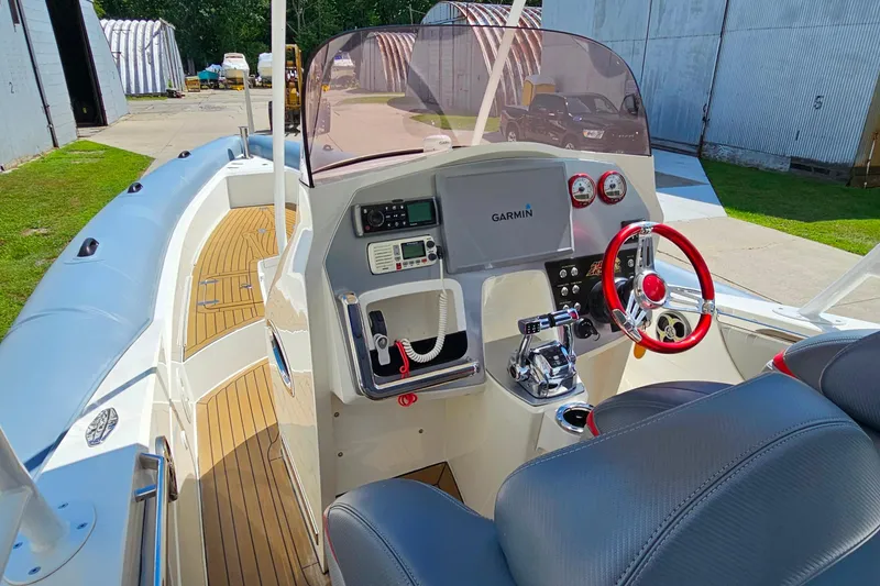 Slide: The Image of 2012 Cougar R10 Rigid Inflatable boat interior with Garmin navigation and red steering wheel. - 15