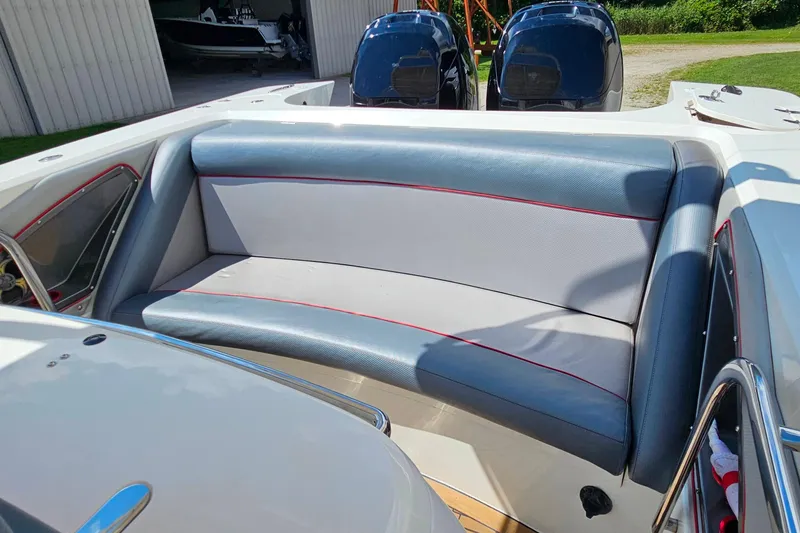 Slide: The Image of 2012 Cougar R10 Rigid Inflatable boat interior with cushioned seating and dual engines. - 19