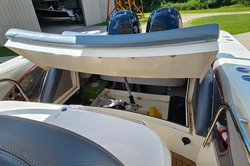 Slide: The Image of 2012 Cougar R10 Rigid Inflatable boat with open engine compartment, showcasing dual motors. - 20