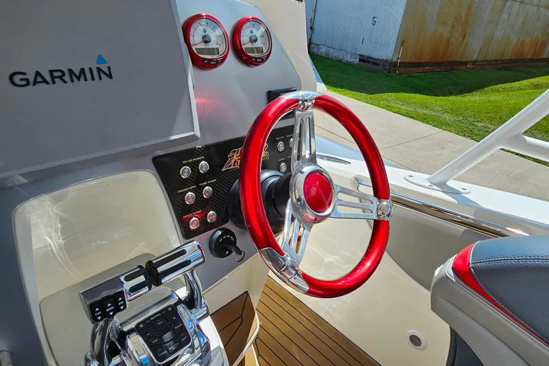 Slide: The Image of Steering wheel and controls of 2012 Cougar R10 Rigid Inflatable boat with Garmin system. - 26