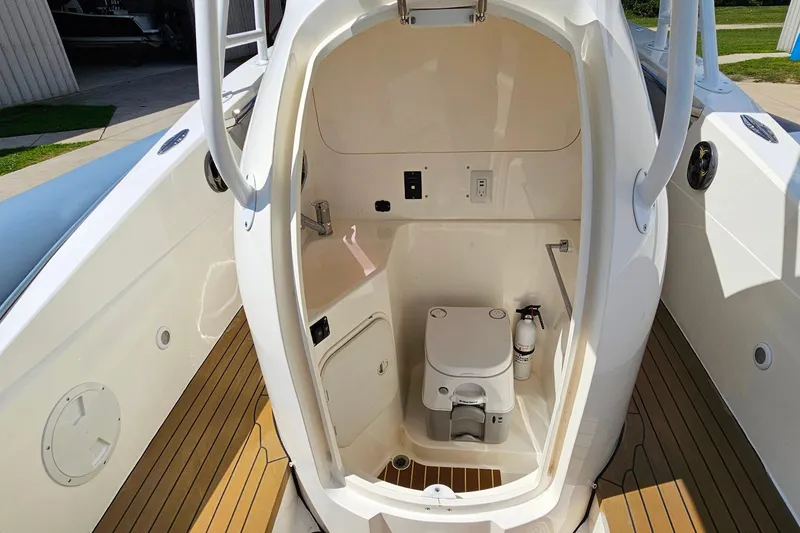 Slide: The Image of 2012 Cougar R10 Rigid Inflatable boat interior with compact marine toilet. - 30