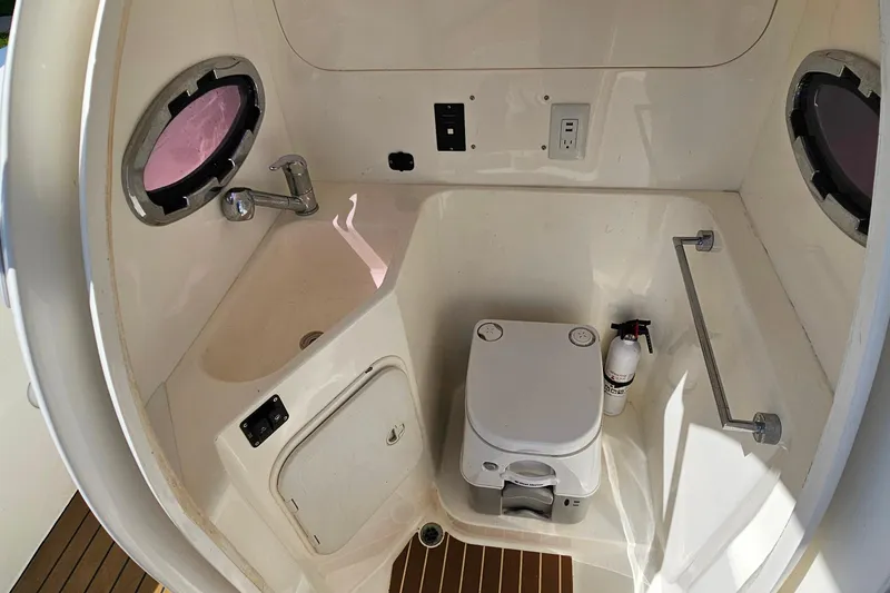 Slide: The Image of 2012 Cougar R10 Rigid Inflatable boat interior with compact bathroom amenities. - 31