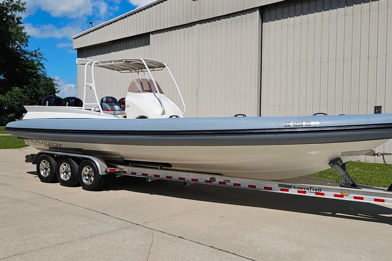 Slide: The Image of 2012 Cougar R10 Rigid Inflatable boat on trailer, parked outdoors. - 40