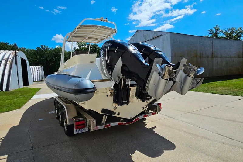 Slide: The Image of 2012 Cougar R10 Rigid Inflatable boat on trailer, dual outboard motors, sunny day. - 6