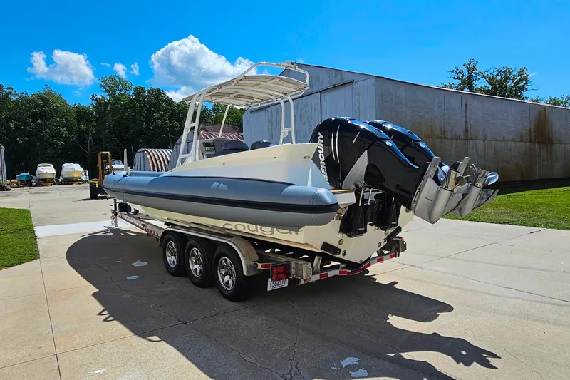 Slide: The Image of 2012 Cougar R10 Rigid Inflatable boat on trailer, featuring dual Mercury outboard engines. - 7