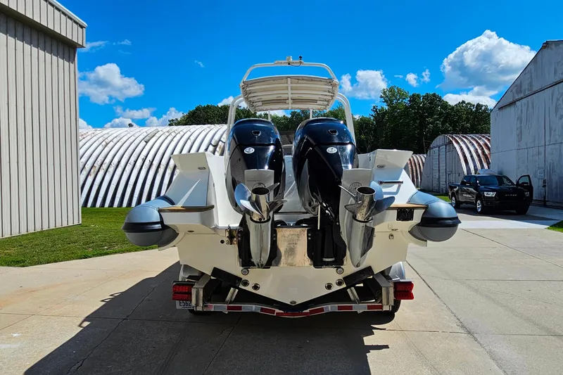 Slide: The Image of 2012 Cougar R10 Rigid Inflatable boat with dual engines on a trailer, sunny day. - 8