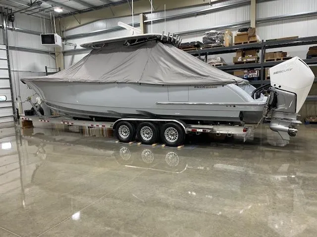 Slide: The Image of 2022 Valhalla Boatworks V 37 covered on trailer in a warehouse setting. - 12