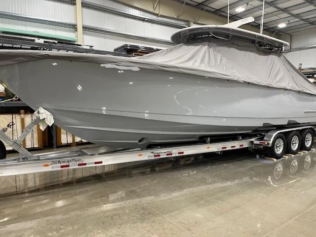 Slide: The Image of 2022 Valhalla Boatworks V 37 on trailer in warehouse, partially covered. - 13