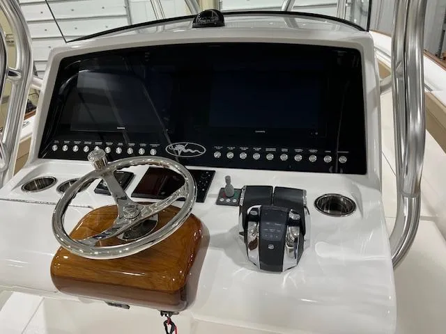 Slide: The Image of 2022 Valhalla Boatworks V 37 helm with steering wheel and control panel. - 28